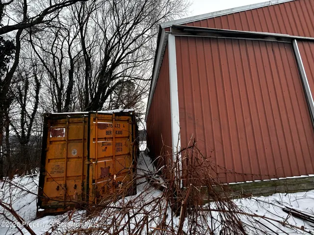 a view of a house with backyard and wooden fence