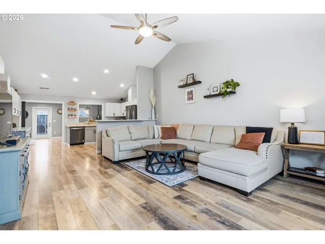 a living room with furniture and kitchen view