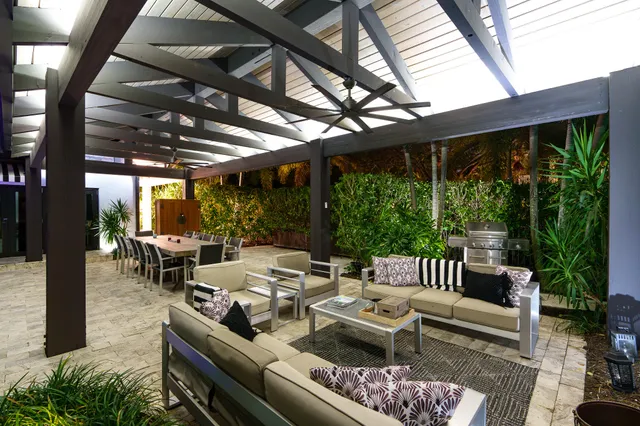 a kitchen with kitchen island granite countertop a sink a counter and cabinets
