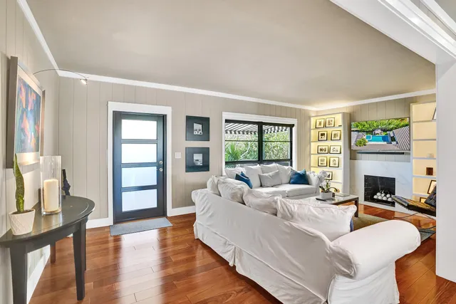 a kitchen with stainless steel appliances granite countertop a sink a stove and a wooden floors