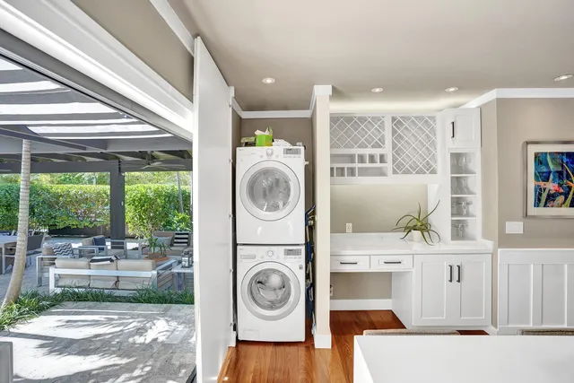a living room with patio furniture and a garden