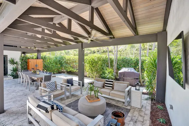 a view of a backyard with swimming pool and furniture