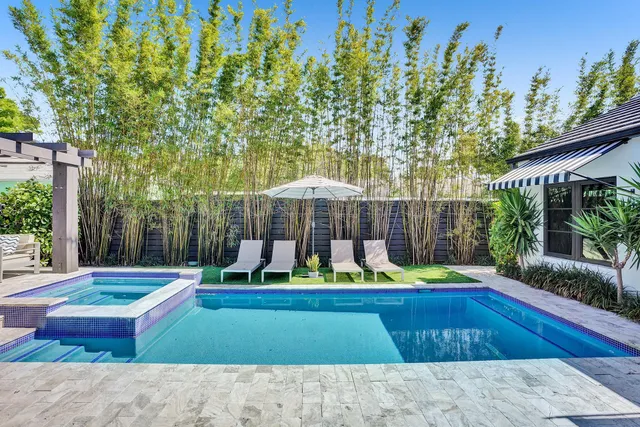 a kitchen with stainless steel appliances granite countertop a stove refrigerator and wooden floor