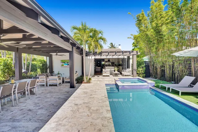 a kitchen with a stove a refrigerator and wooden floor