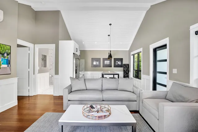 a kitchen with stainless steel appliances kitchen island granite countertop a sink and wooden floors