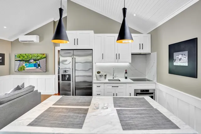 a bathroom with a sink vanity mirror and toilet