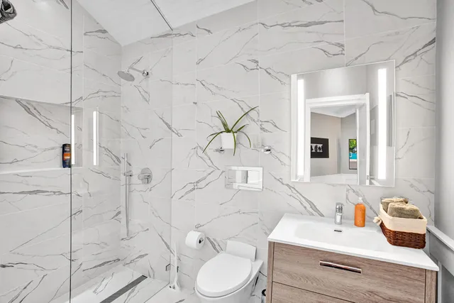 a bathroom with a shower and a plant