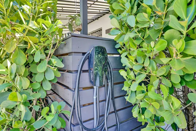a group of tables and chairs under an umbrella in the patio