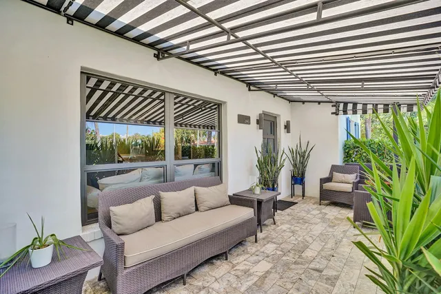 a living room with furniture and a potted plant