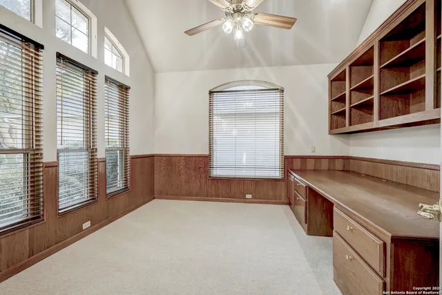 a view of an empty room with a cabinet and a window