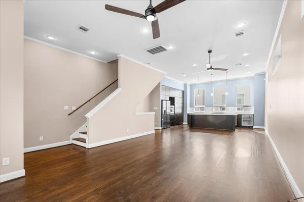 a view of entryway and kitchen with wooden floor
