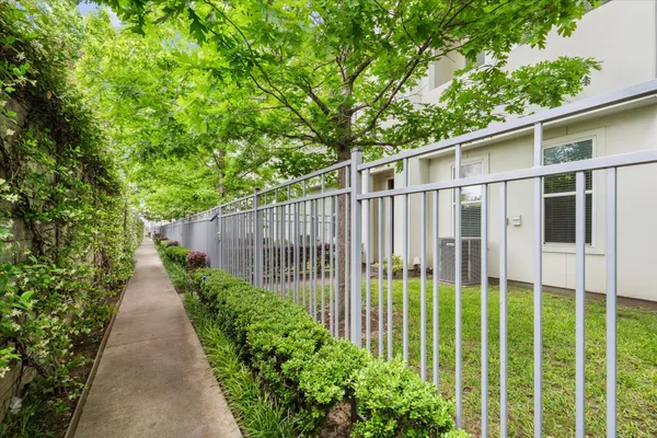 a view of a garden with wooden fence