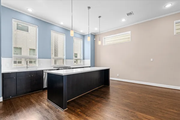 a large kitchen with stainless steel appliances a large island in it