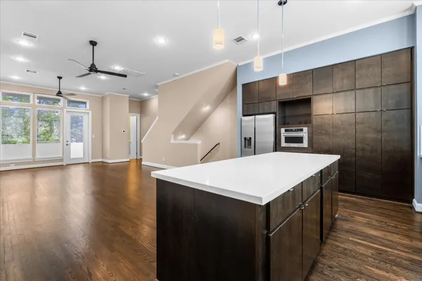 a kitchen with a wooden floor and window