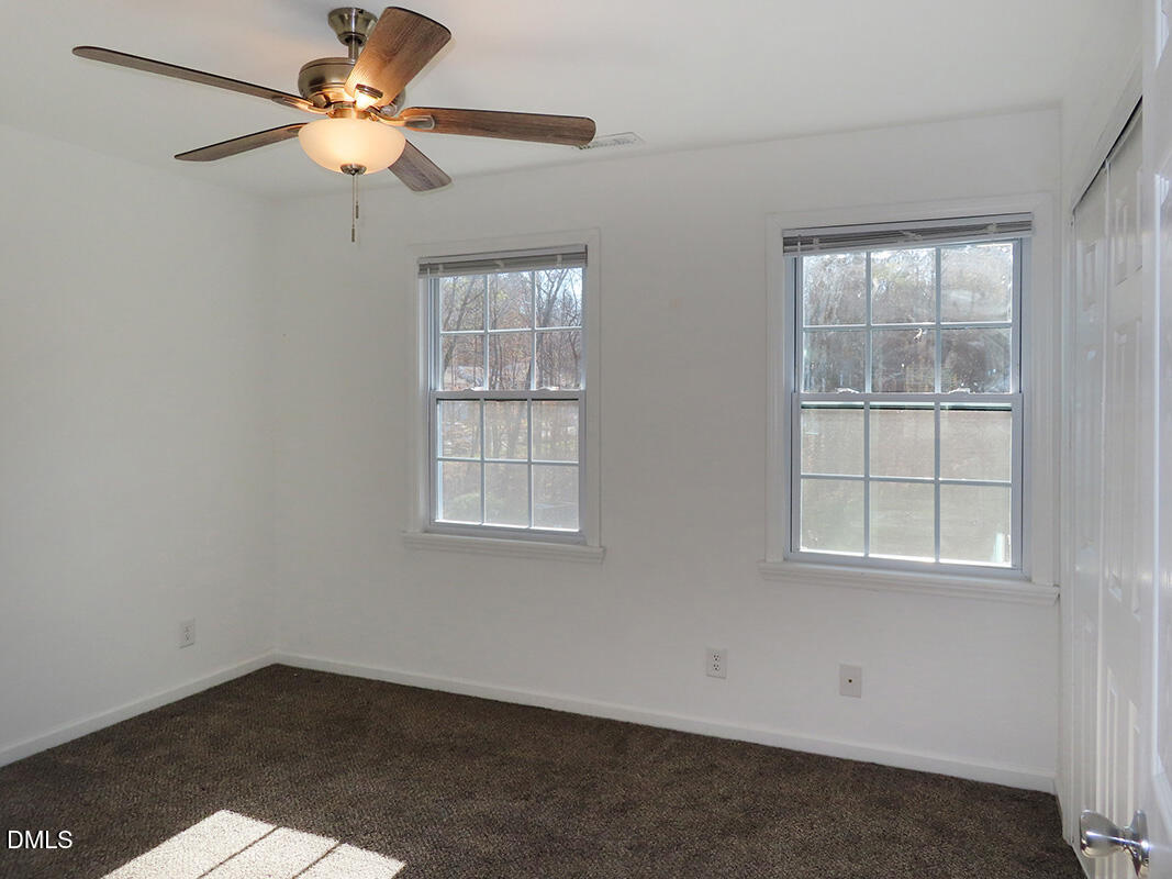 101 Rock Haven Road, Unit G704 Carrboro, NC 27510 - Photo 13 of 24 an empty room with windows and fan