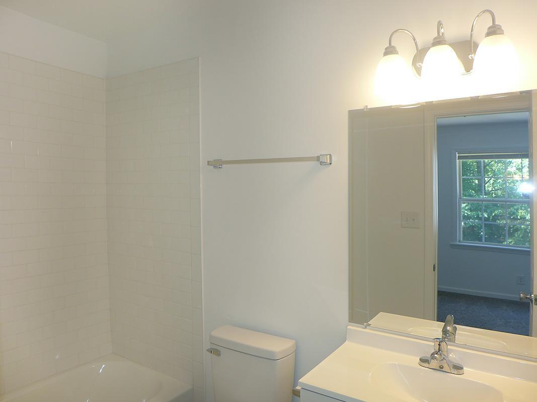 101 Rock Haven Road, Unit G704 Carrboro, NC 27510 - Photo 16 of 24 a bathroom with a sink a toilet and shower