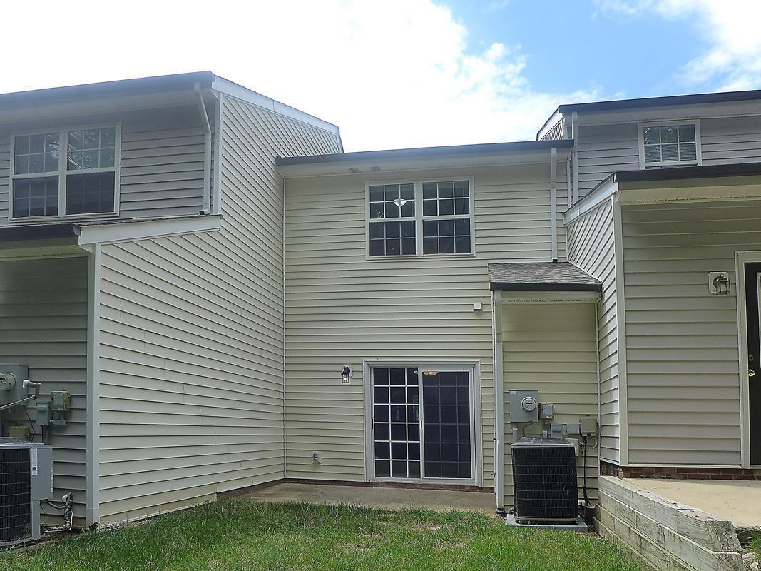 101 Rock Haven Road, Unit G704 Carrboro, NC 27510 - Photo 17 of 24 a view of a house with a yard and a large window