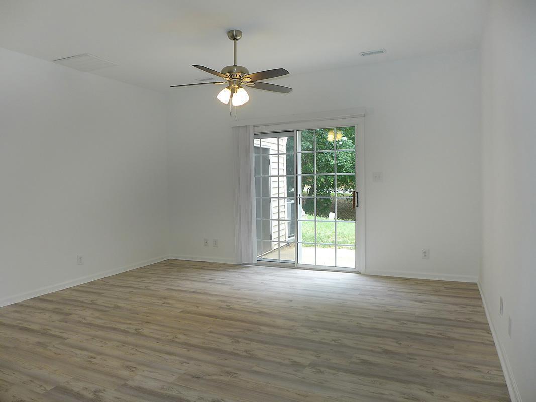 101 Rock Haven Road, Unit G704 Carrboro, NC 27510 - Photo 4 of 24 a view of an empty room with wooden floor and a window