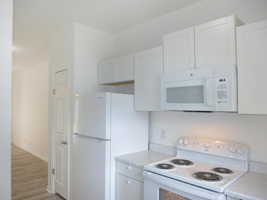 101 Rock Haven Road, Unit G704 Carrboro, NC 27510 - Photo 10 of 24 a kitchen with a stove and a microwave