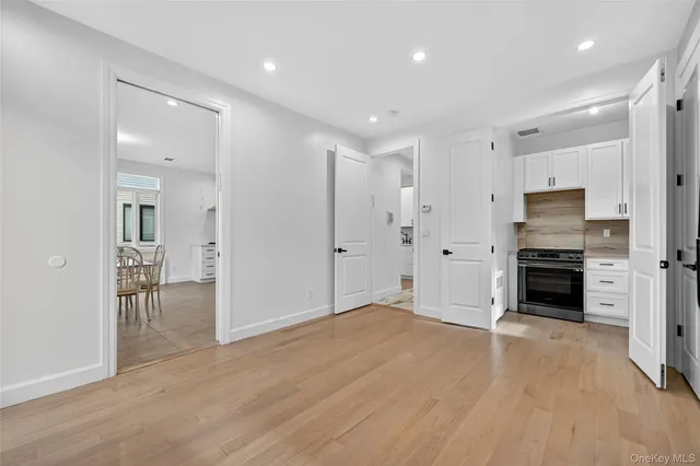 a view of a kitchen with a sink stove refrigerator and cabinets
