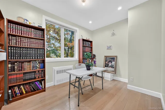 a view of a workspace with furniture and a book shelf