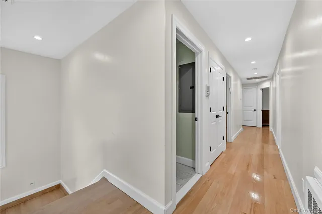 a view of a hallway with wooden floor