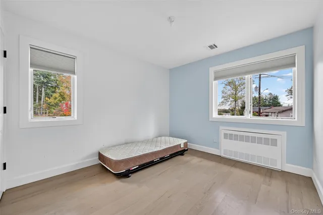 a room with window and a dresser