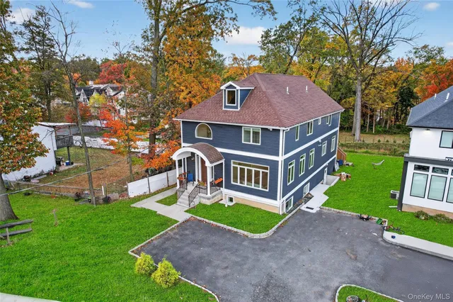 a aerial view of a house with a yard and plants