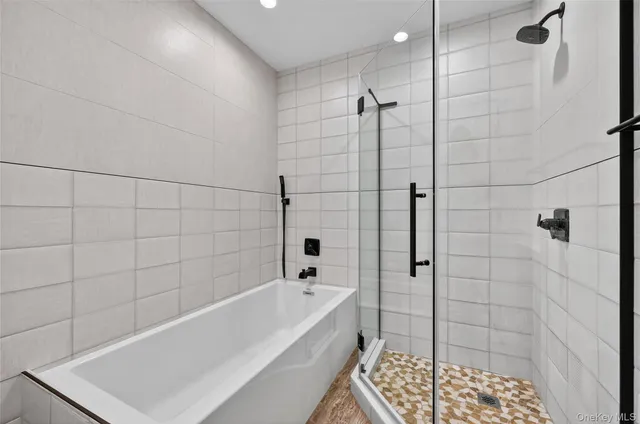 a bathroom with a bathtub and shower