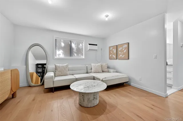 a living room with furniture and a painting on the wall