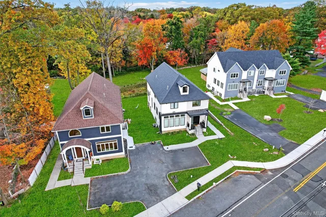 an aerial view of a house with garden space and street view