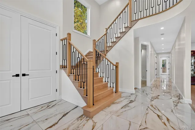 a view of a hallway with wooden floor and staircase