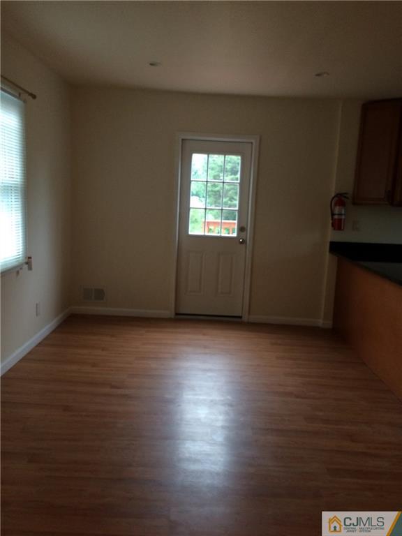 534 Chain O' Hills Road Colonia, NJ 07067 - Photo 3 of 6 an empty room with wooden floor and windows