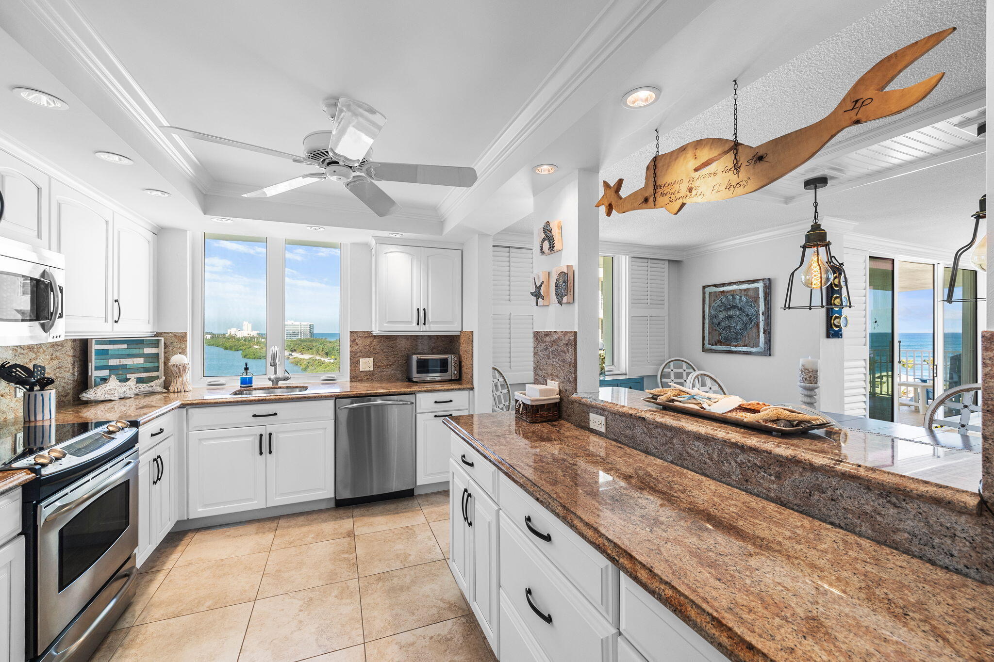 375 South Beach Road, Unit 802 Tequesta, FL 33469 - Photo 13 of 39 a kitchen with a stove sink and cabinets