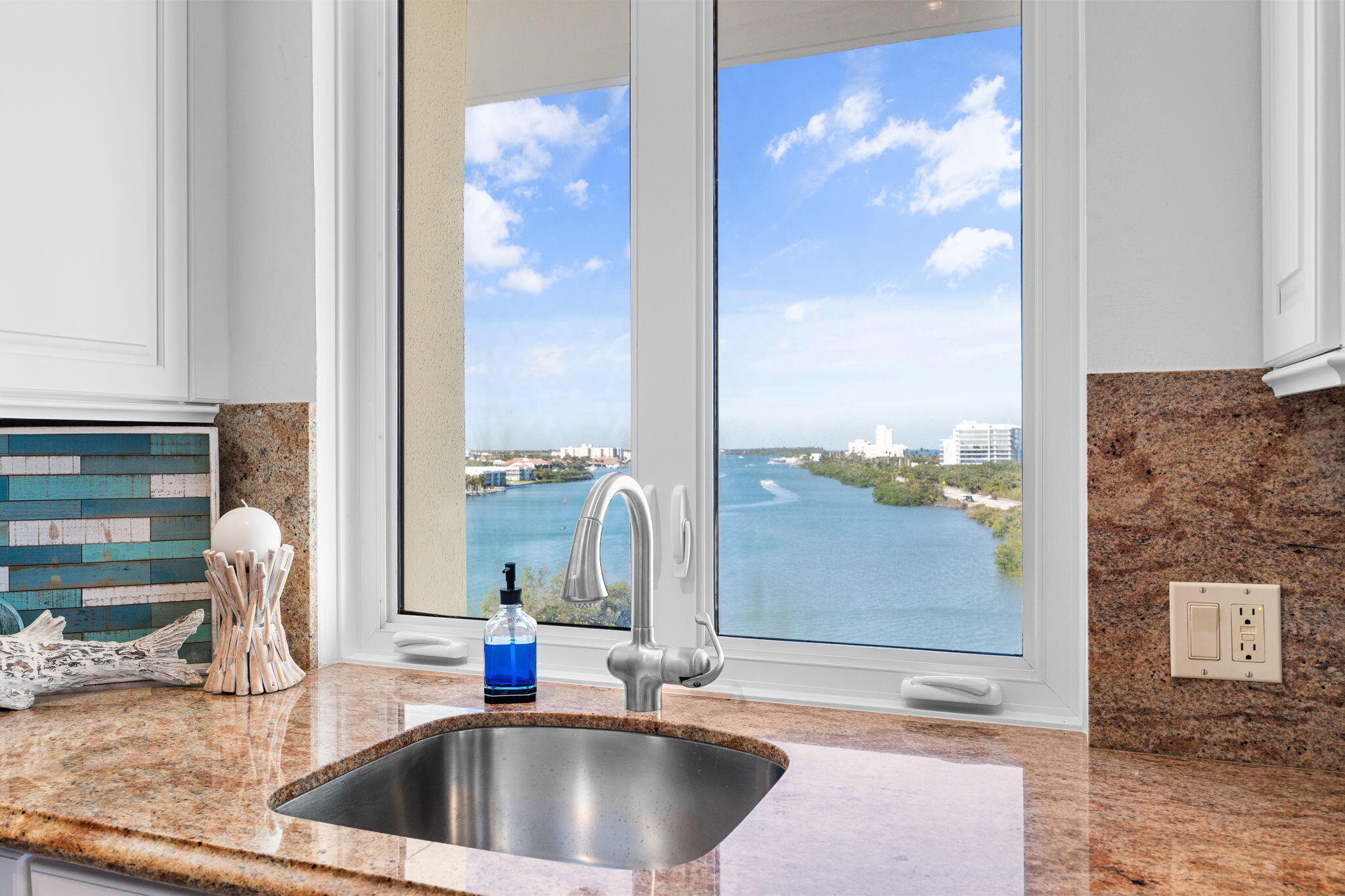 375 South Beach Road, Unit 802 Tequesta, FL 33469 - Photo 15 of 39 a sink with a view of living room
