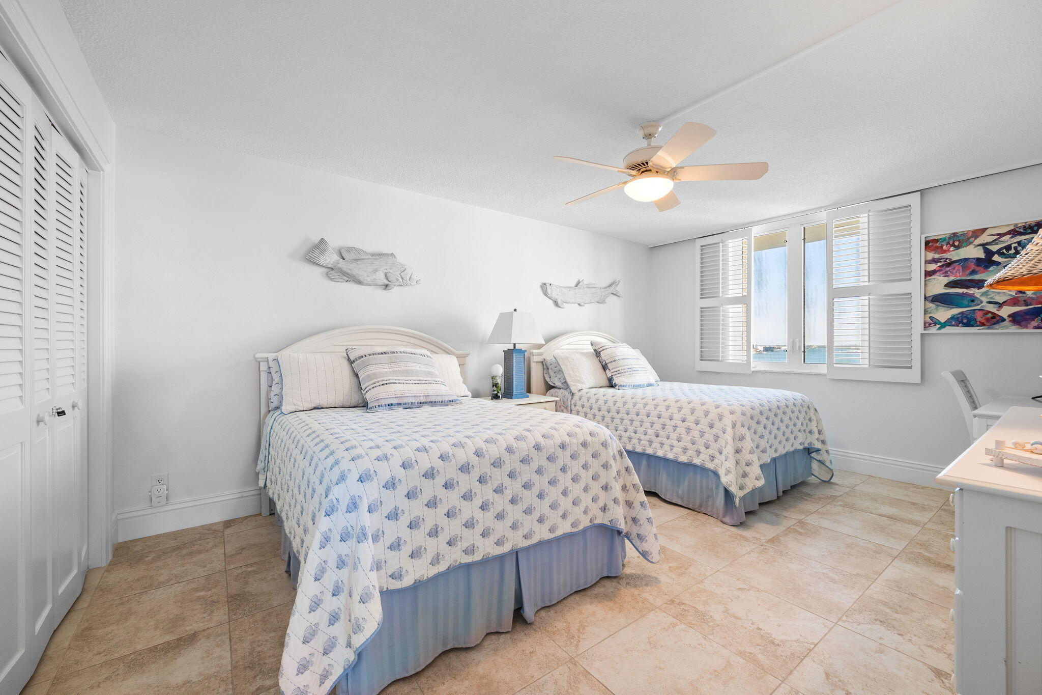 375 South Beach Road, Unit 802 Tequesta, FL 33469 - Photo 23 of 39 a bedroom with two beds and a chandelier