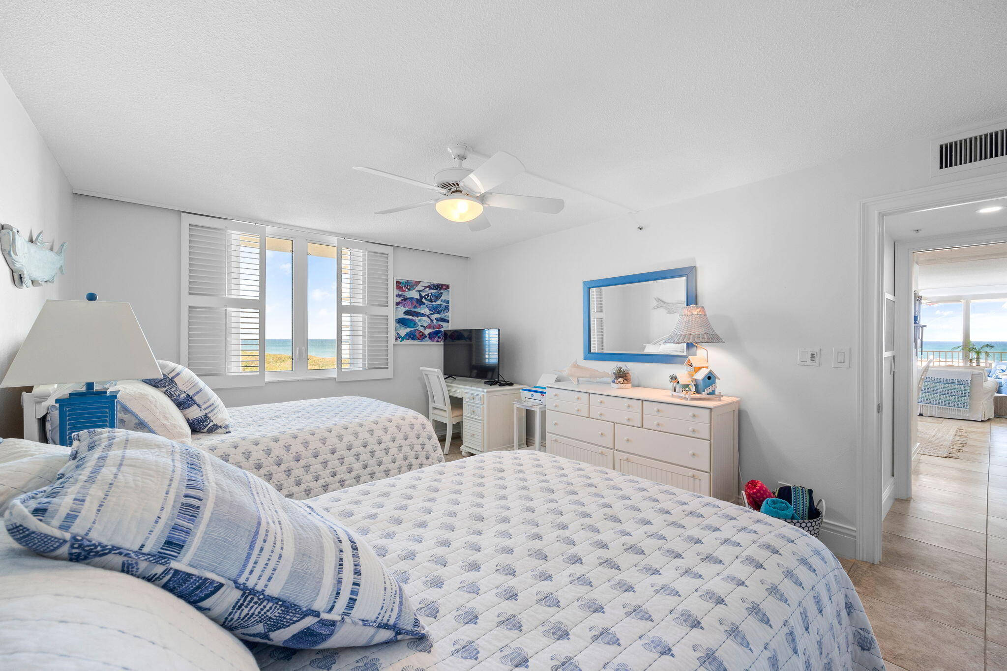 375 South Beach Road, Unit 802 Tequesta, FL 33469 - Photo 24 of 39 a bedroom with two beds and a chandelier