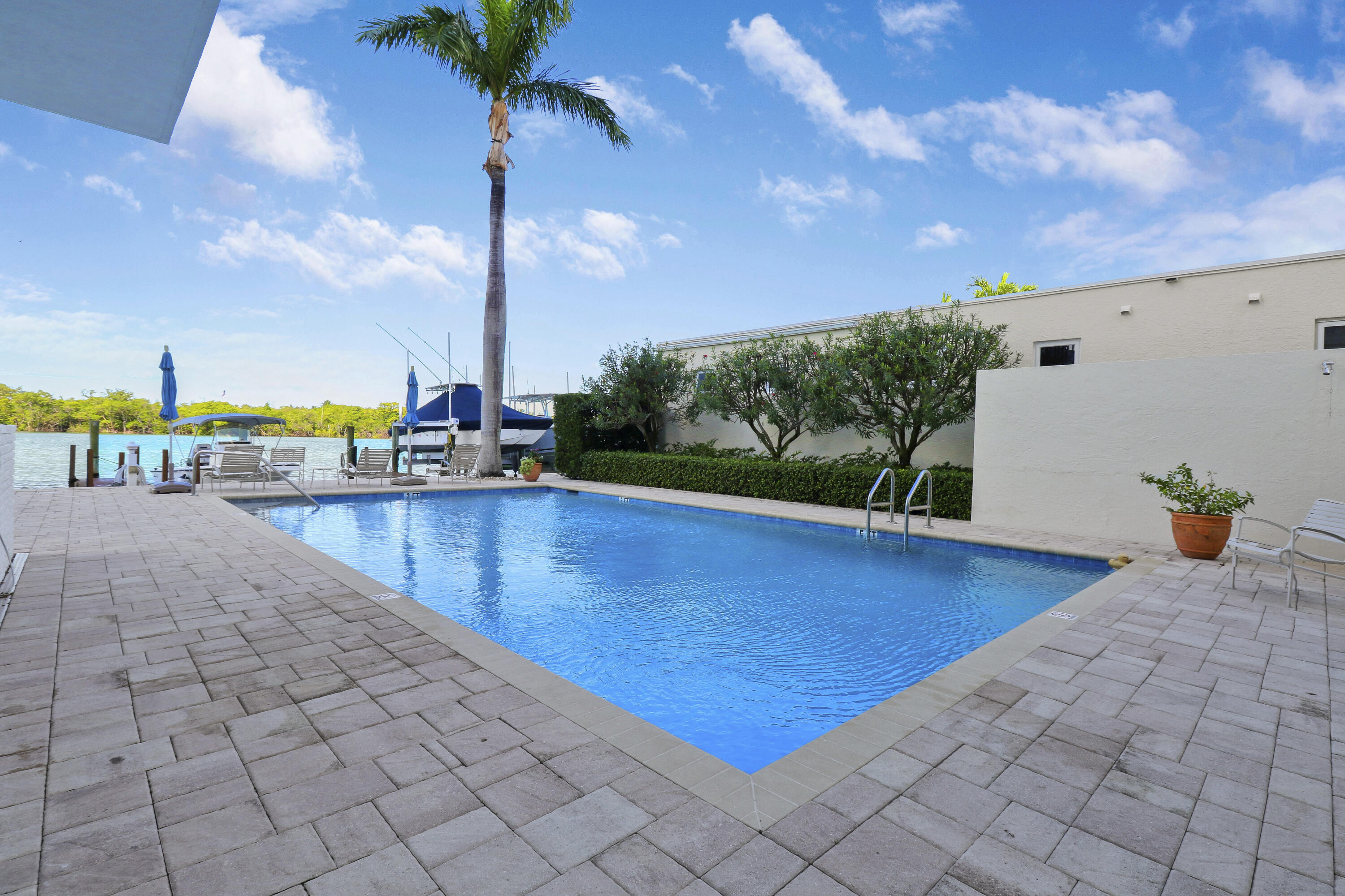 375 South Beach Road, Unit 802 Tequesta, FL 33469 - Photo 38 of 39 a view of a swimming pool with a lounge chairs