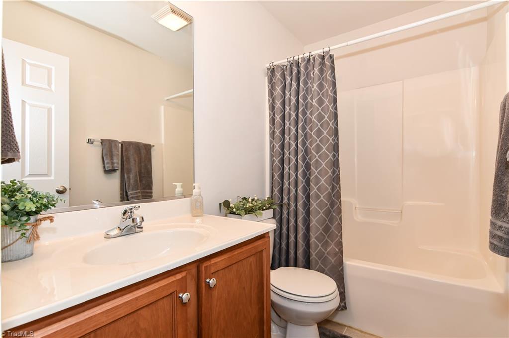 467 Ansley Way High Point, NC 27265 - Photo 11 of 16 The hall full bath has a large oak vanity, tub/shower combo, tile look flooring. The upper landing has new wood laminate flooring and a linen closet.