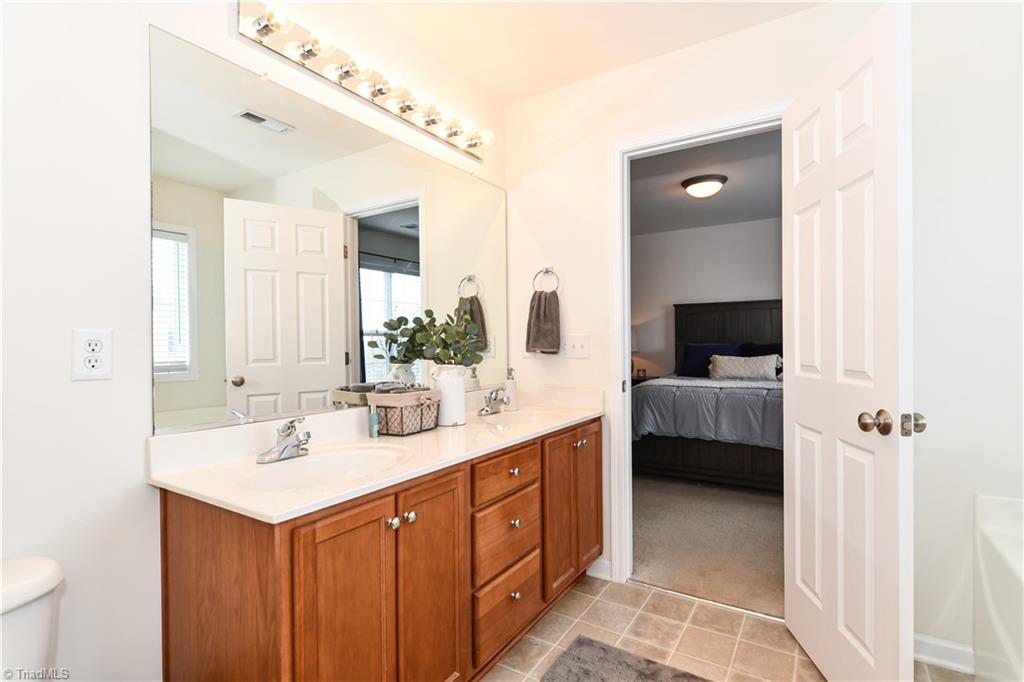 467 Ansley Way High Point, NC 27265 - Photo 13 of 16 The master bath has tile look flooring, double sink large vanity, soaking tub, and separate shower.