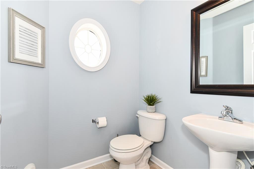 467 Ansley Way High Point, NC 27265 - Photo 4 of 16 Powder room tucked in nicely towards the staircase...privately located.