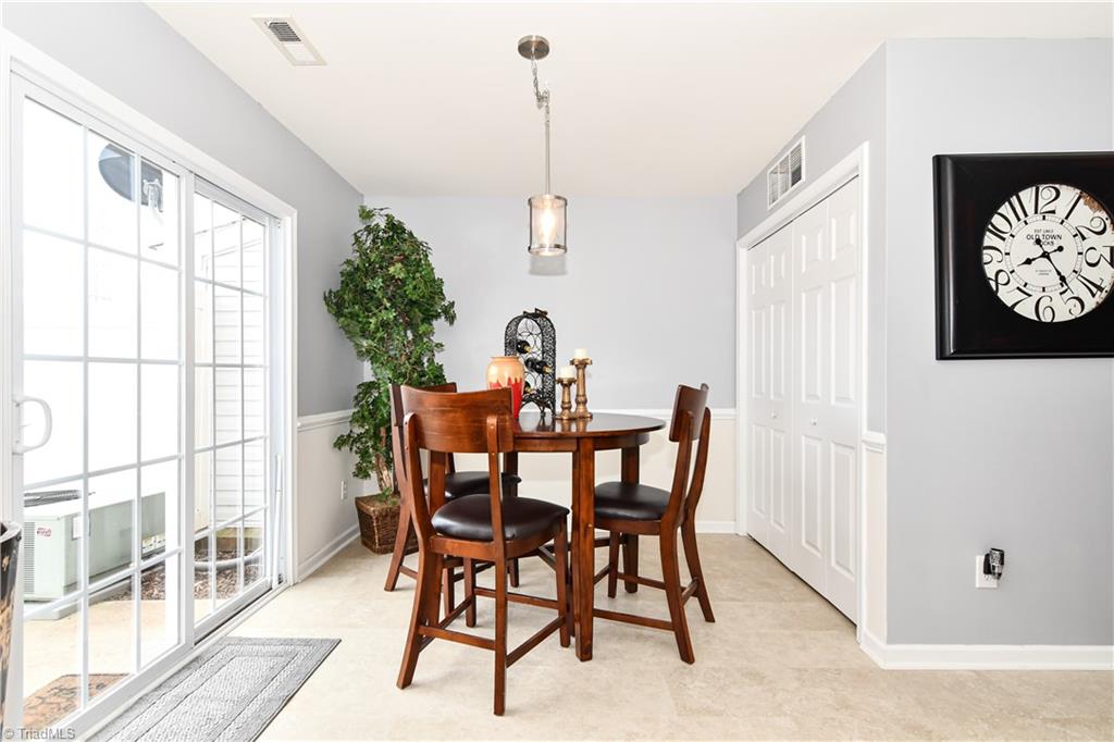 467 Ansley Way High Point, NC 27265 - Photo 7 of 16 View from kitchen looking into the dining room. Chair rail molding and updated lighting, plus private patio view and convenient main level laundry.