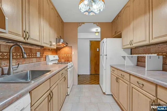 a kitchen with cabinets a sink and appliances