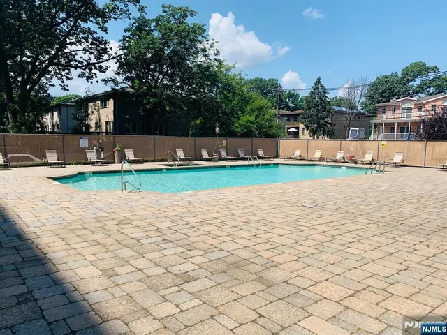a view of a swimming pool and a yard