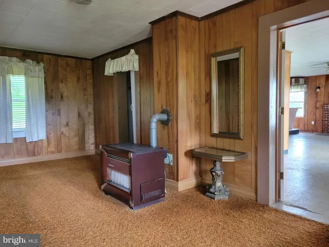 an empty room with furniture and a fireplace