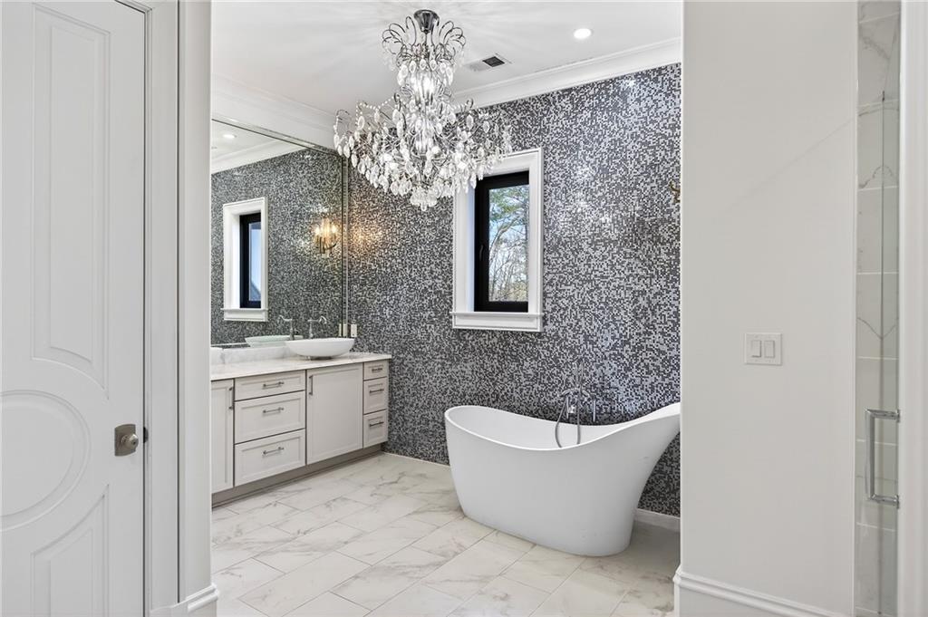 5320 Riverview Road Northwest Atlanta, GA 30339 - Photo 36 of 83 a bathroom with a granite countertop bathtub sink and mirror