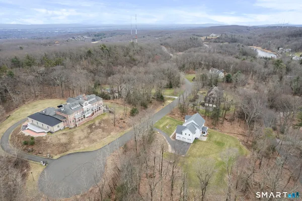 an aerial view of a house with yard