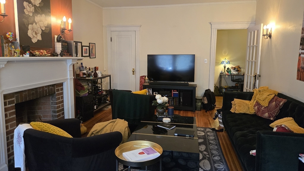 1986 Commonwealth, Unit 4 Boston, MA 02135 - Photo 3 of 10 a living room with furniture and a flat screen tv
