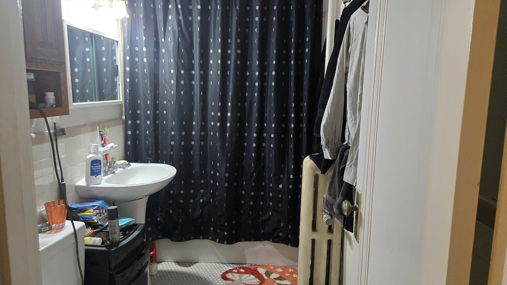 1986 Commonwealth, Unit 4 Boston, MA 02135 - Photo 9 of 10 a bathroom with a sink toilet and shower