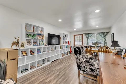 a bed sitting in a bedroom next to a window